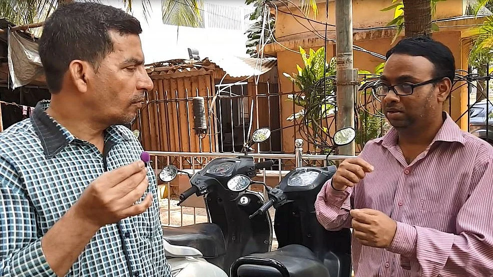 Madhukar Yogi (right) takes the help of a colleague to explain his worries about being unemployed. 