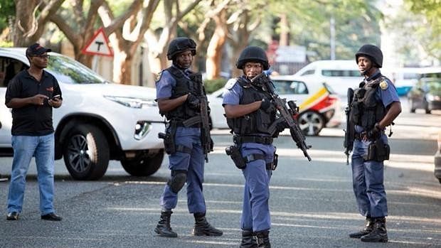 Police close off roads around the home of the Gupta family, friends of President Jacob Zuma, in Johannesburg on 14 February.