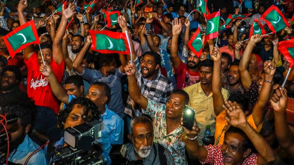 Maldivian opposition protestors shout slogans demanding the release of political prisoners during a protest in Male, Maldives.