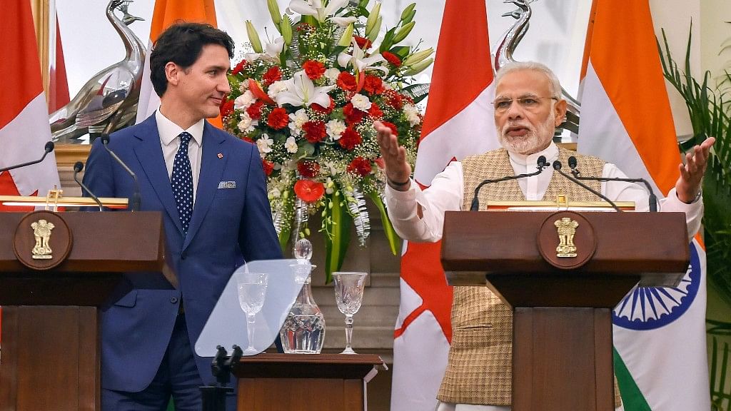 PM Modi speaks as his Canadian counterpart Justin Trudeau looks on, during their joint press conference