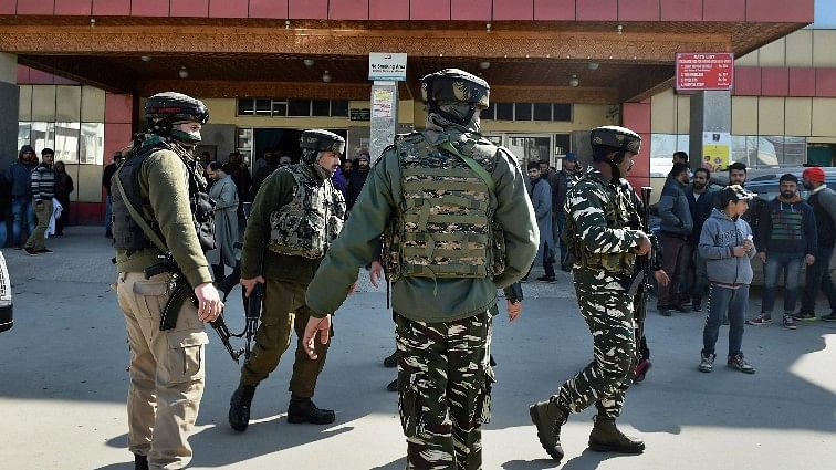 Security personnel stand guard during a search operation after an LeT militant escaped from the police custody with the assailants after Lashkar-e-Taiba militants attacked SMHS hospital, in Srinagar on 6 February.