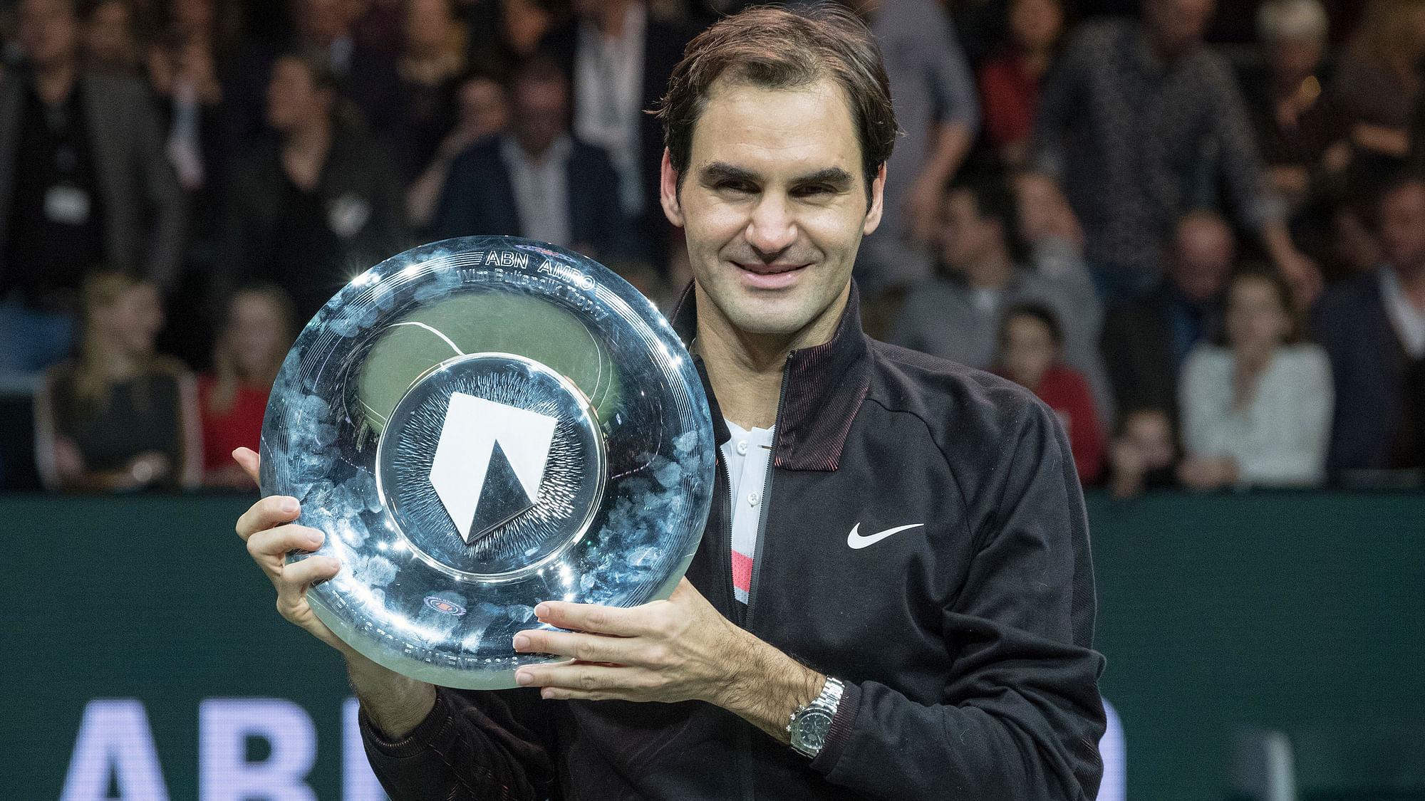 Roger Federer  holds the trophy after winning his match against Bulgaria’s Grigor Dimitrov in two sets, 6-2, 6-2, in the men’s singles final of the ABN AMRO tournament