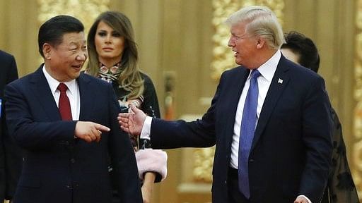 US President Donald Trump and China’s President Xi Jinping arrive for the state dinner with the first ladies at the Great Hall of the People in Beijing on 9 November 2017.