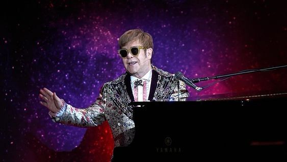Elton John on stage, performing live.&nbsp;