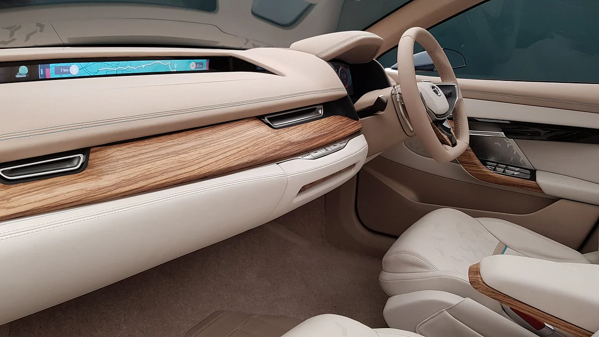 The wood and leather finish looks premium on the interiors. Notice the LCD display for passengers. 