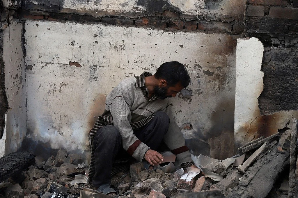 Ghulam looks for his poetry in the rubble after the Khanmoh encounter. He has lost over 1,000 pages of his unpublished poetry. 