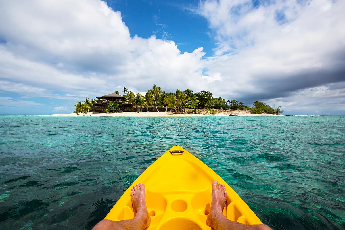 Kayaking by a tropical island in Fiji. 