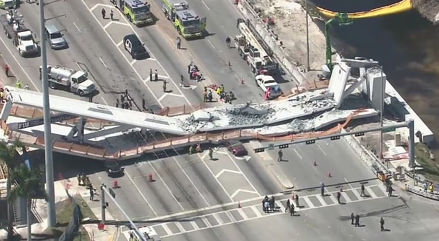 In this frame from video, emergency personnel work at the scene of a collapsed bridge in Miami on Thursday, 15 March.