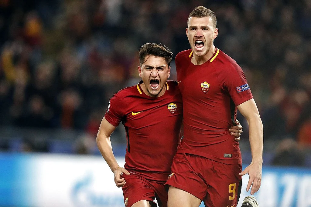 Roma’s Edin Dzeko, right, celebrates with his teammate Cengiz Under after scoring against Shakhtar Donetsk.