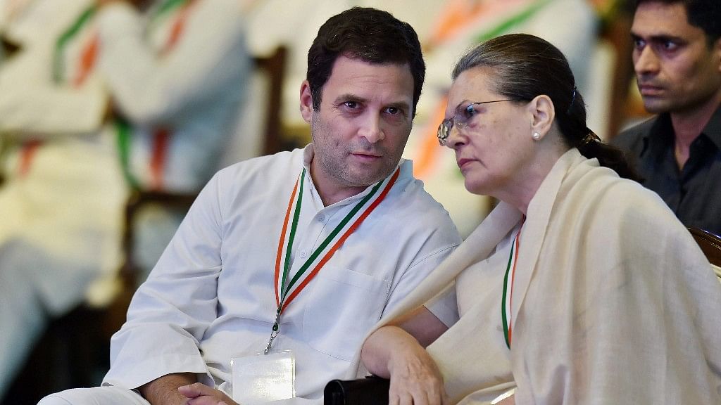 UPA chairperson Sonia Gandhi and Congress President Rahul Gandhi talk during the 84th Plenary Session of Indian National Congress in New Delhi on 17 March.