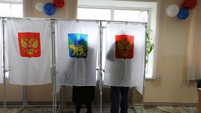 Voters write ballots at a polling station in Vladivostok, east Russia, 18 March  2018.