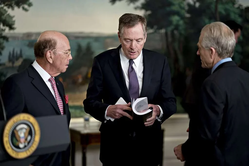 Peter Navarro, director of the National Trade Council, from right, Robert Lighthizer, US trade representative, and Wilbur Ross, US commerce secretary, speak before US President Donald Trump, not pictured, signs a presidential memorandum targeting China’s economic aggression in the Diplomatic Room of the White House in Washington, DC, US, on 22 March 2018.