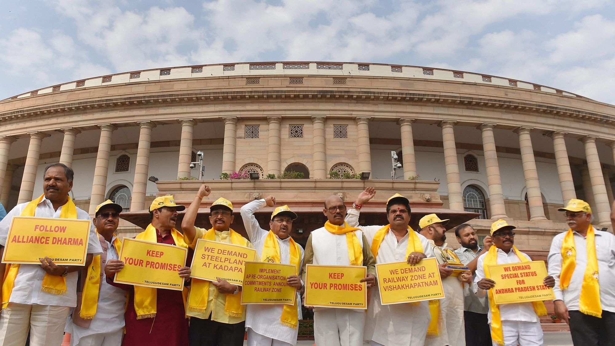 TDP party leaders hold placards and raise slogans demanding special status for Andhra Pradesh during the budget session.