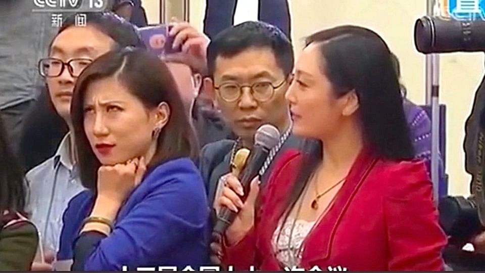 Picture of Liang Xiangyi rolling her eyes at her colleague Zhang Huijun of AMT.