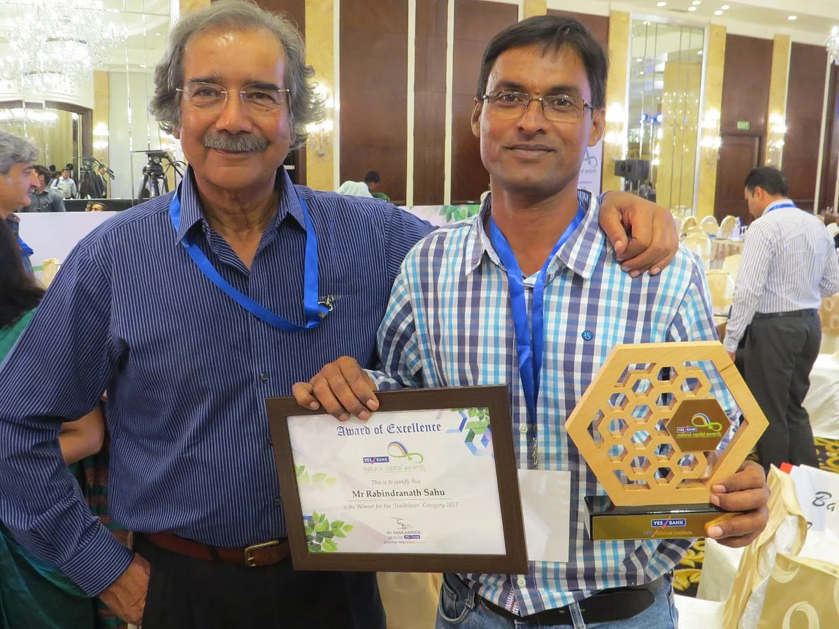 Rabindranath Sahu (R) receives an award for his efforts in wildlife conservation.