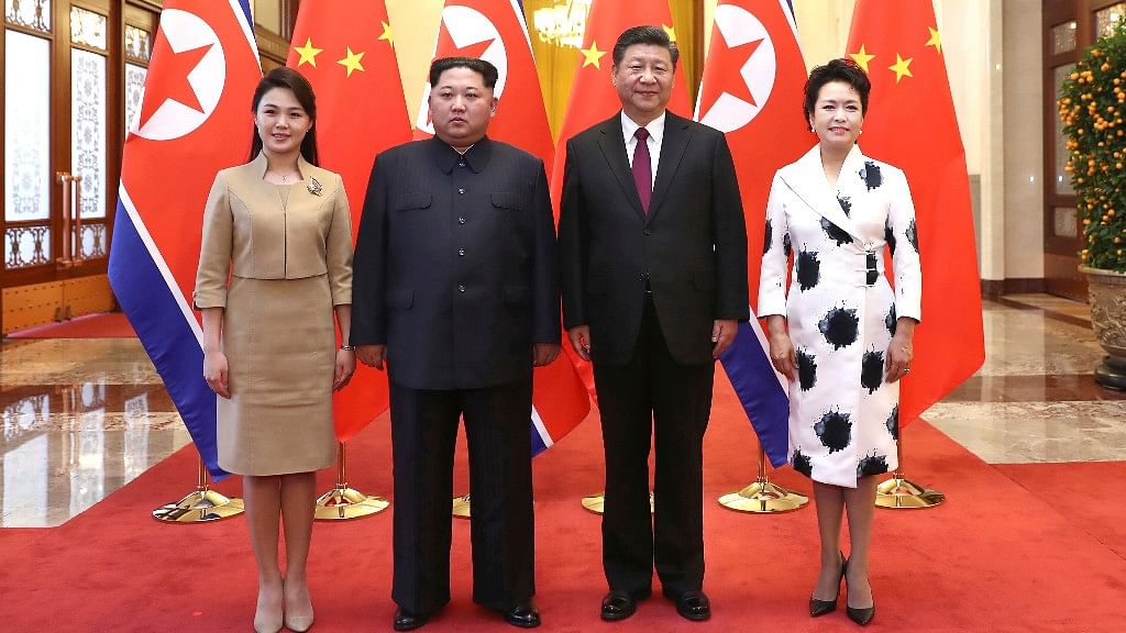 Chinese President Xi Jinping and North Korean leader Kim Jong Un with their wives pose for a photo at the Great Hall of the People in Beijing. 