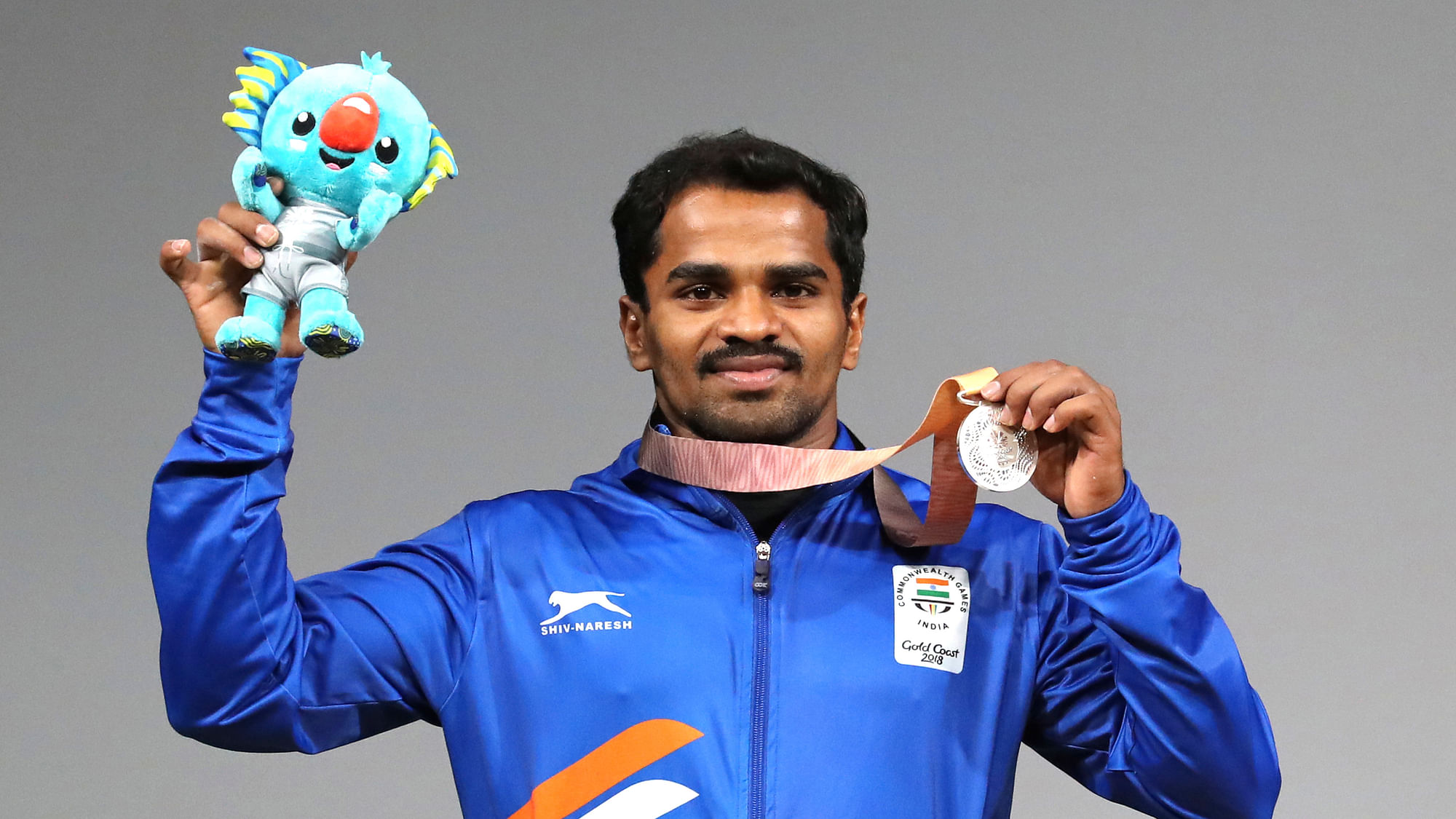 India’s Gururaja shows his Silver medal and mascot Borbi after wining in the Men’s 56kg Weightlifting final during Commonwealth Games in Gold Coast, Australia, Thursday, April 5, 2018.&nbsp;