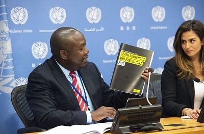 Amnesty International Senior Director for Law and Policy Tawanda Mutasah hold up the Global Report on Death Sentences and Executions 2017 at a briefing he and the organisation