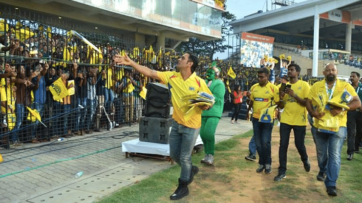 File photo of MS Dhoni distributing souvenirs to CSK fans at Chepauk. &nbsp;