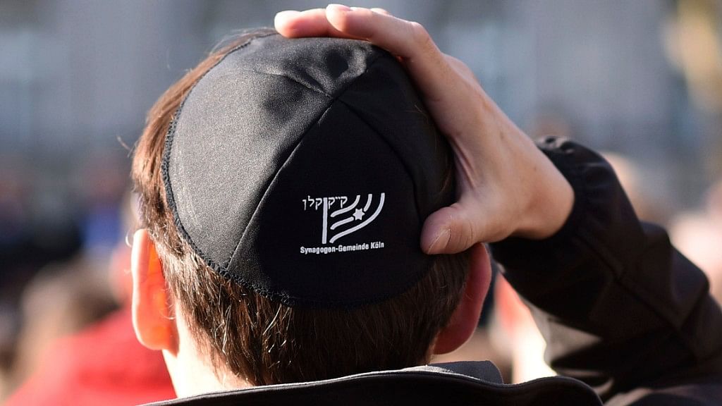 Germans of various faiths donned Jewish skullcaps and took to the streets Wednesday in several cities to protest an anti-Semitic attack in Berlin.