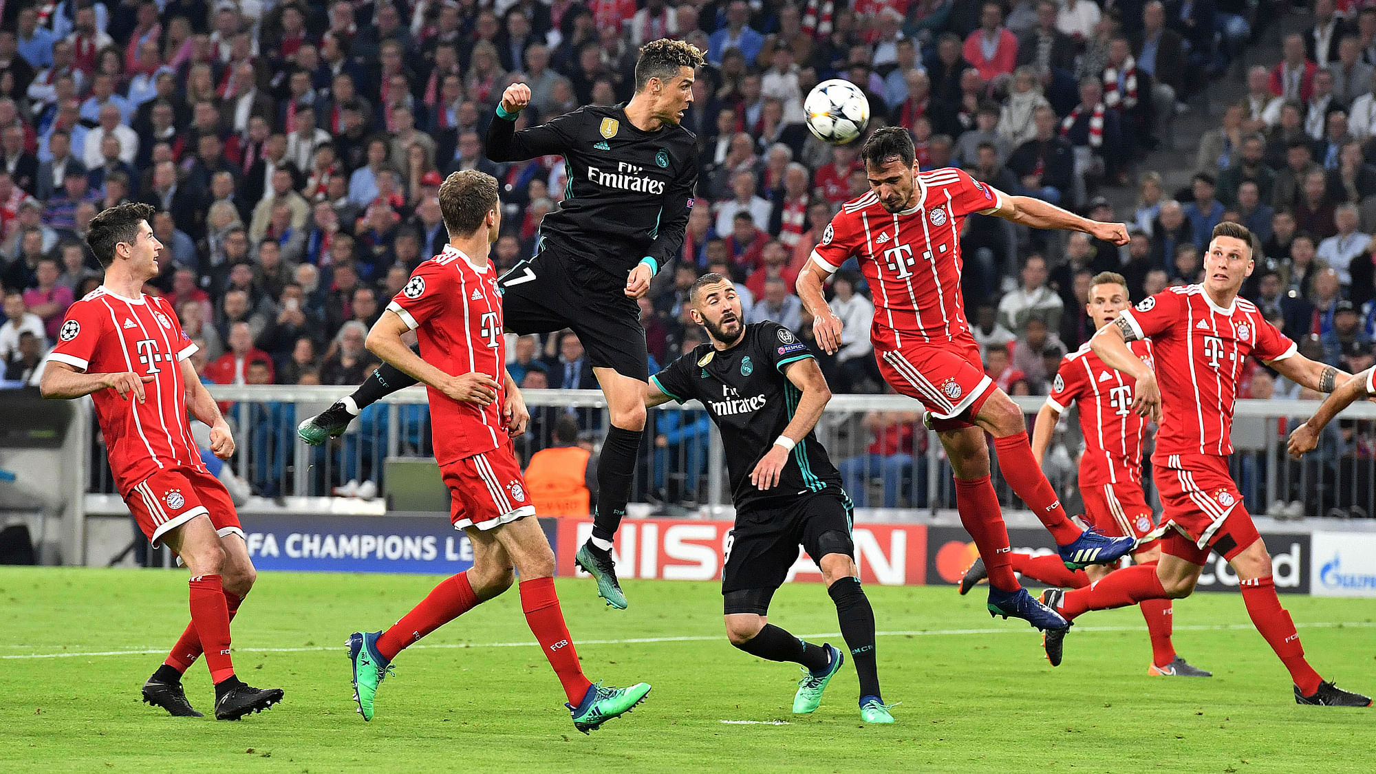 Real Madrid’s Cristiano Ronaldo, center, heads the ball during the semifinal first leg soccer match between FC Bayern Munich and Real Madrid at the Allianz Arena stadium in Munich, Germany, Wednesday, April 25, 2018.&nbsp;
