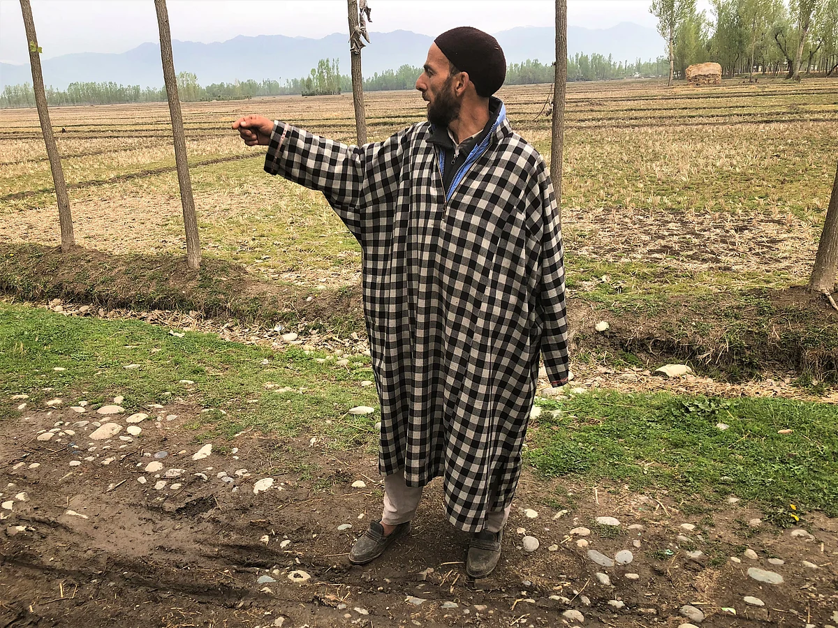 Bhat’s uncle pointing in the direction where Manzoor’s beheaded body was found on Friday. 