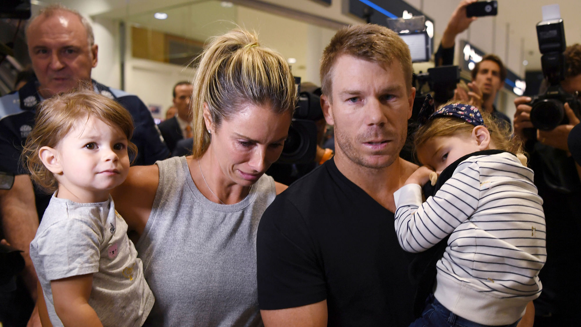 David Warner and his wife Candice at the Sydney airport with their daughters.