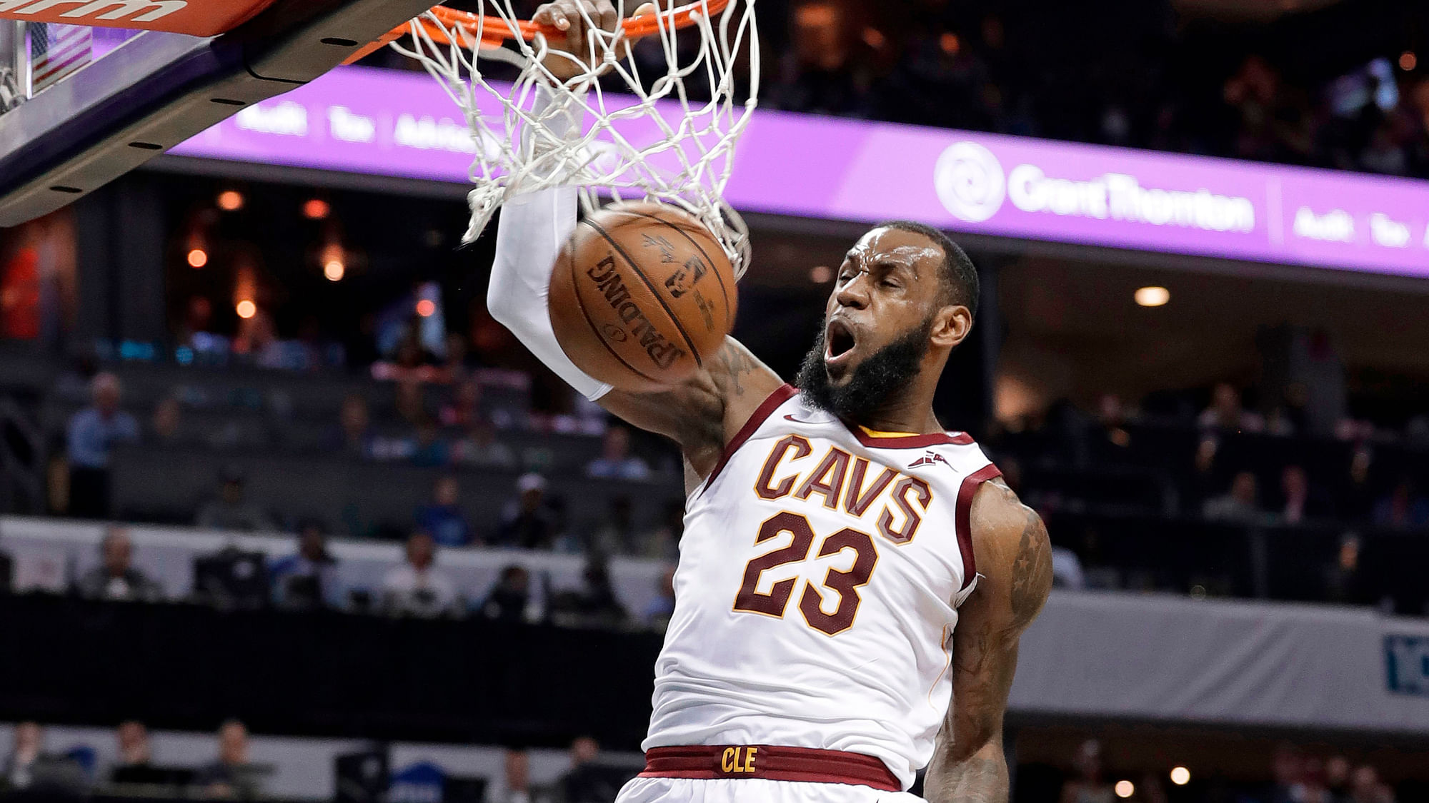 Cleveland Cavaliers’ LeBron James (23) dunks past Charlotte Hornets’ Dwight Howard (12) during the second half of an NBA game in Charlotte, N.C