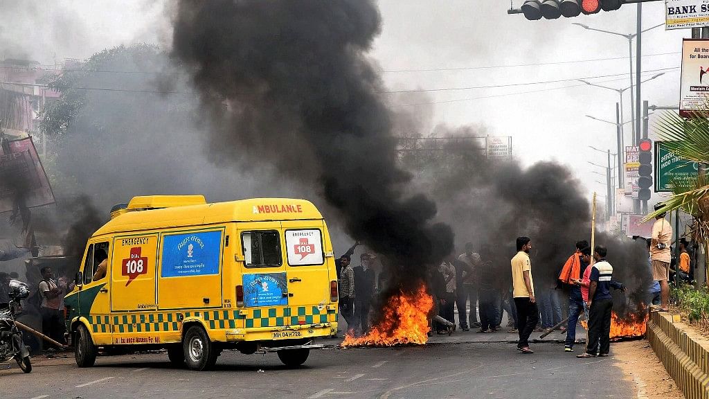 Protestors burn a tyre on a road during ‘Bharat Bandh’ protests in Patna, Bihar, on Tuesday.