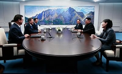 PANMUNJOM, April 27, 2018 (Xinhua) -- Photo taken on April 27, 2018 from TV screen shows South Korean President Moon Jae-in (2nd L) meeting with top leader of the Democratic People