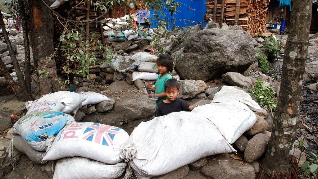 Refugee children play in a makeshift bomb-shelter made with sandbags at Woi Chyai camp for refugees close to Laiza, northern Kachin state, Myanmar. 