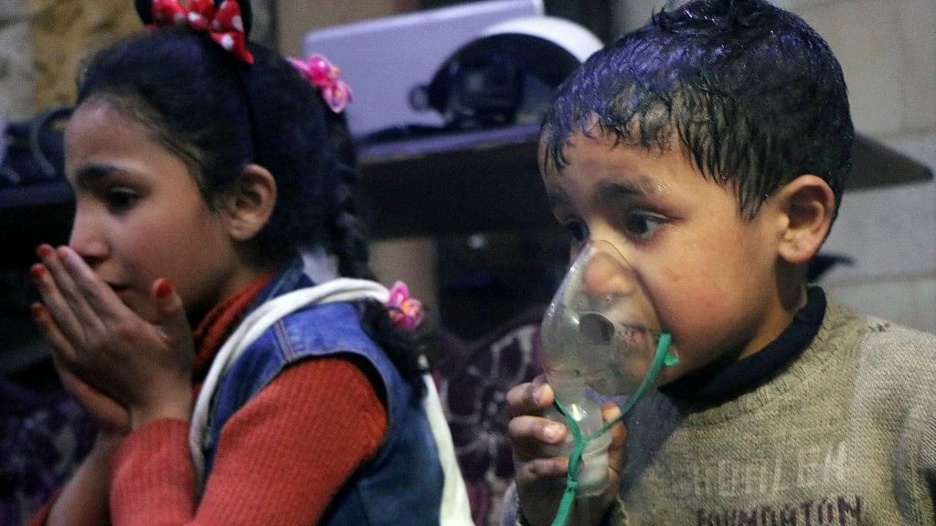 This image released early Sunday, April 8, 2018 by the Syrian Civil Defense White Helmets, shows a child receiving oxygen through respirators following an alleged poison gas attack in the rebel-held town of Douma, near Damascus, Syria.