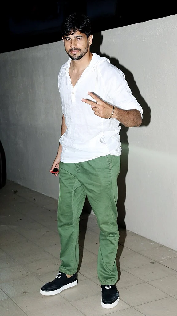 Sidharth Malhotra strikes a pose for paparazzi outside a salon in Mumbai. 