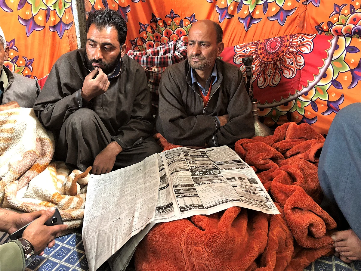 Abdul Gaffar Bhat (right) at his residence in Hajin after his son’s killing. 