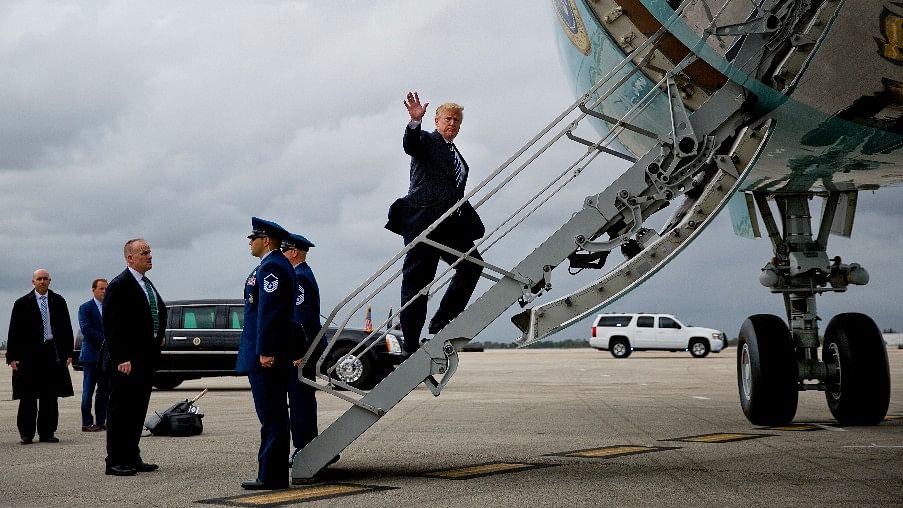 US President Donald Trump waves while boarding Air Force One.