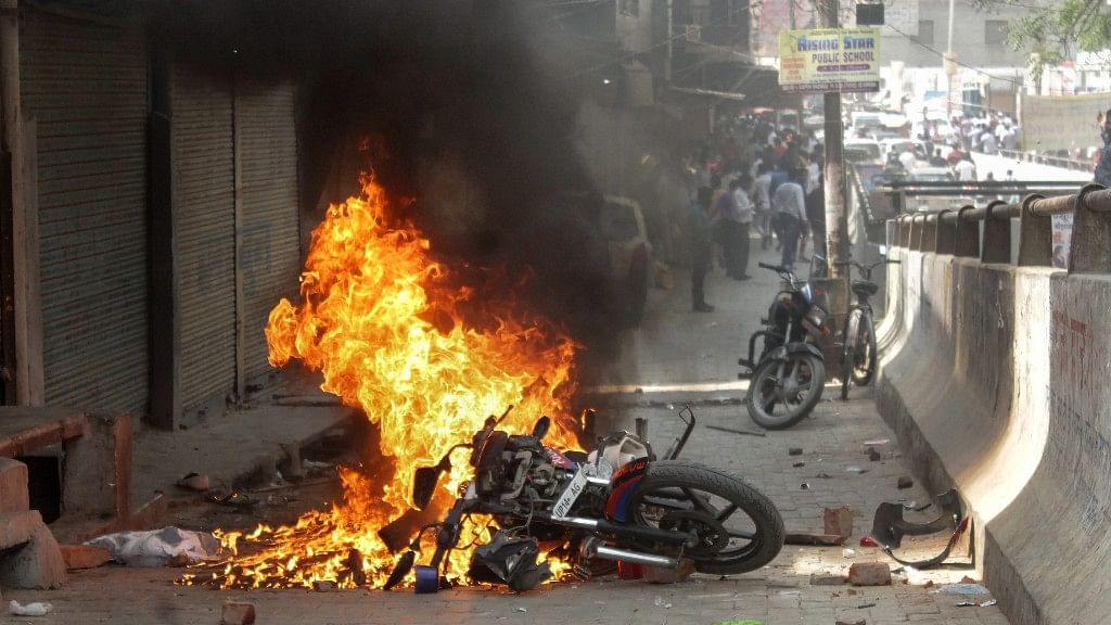A bike set on fire by a group of protesters during Bharat Bandh against the alleged dilution of Scheduled Castes / Scheduled Tribes Act, in Ghaziabad on Monday.