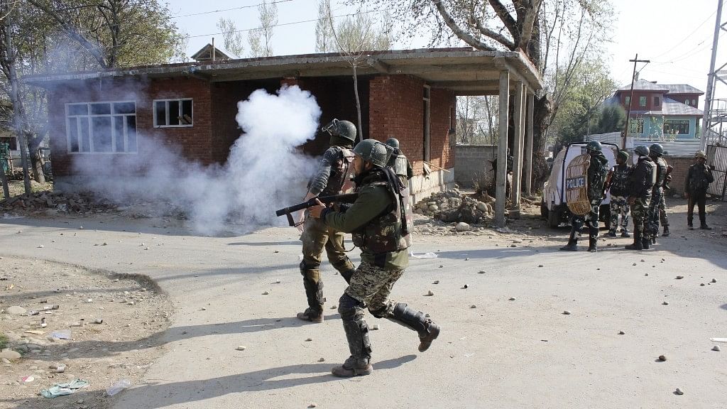 Security personnel fire tear gas shells at protesters hurling stones at them in Jammu and Kashmir’s Shopian district after security forces shot dead 11 militants on 1 April.&nbsp;