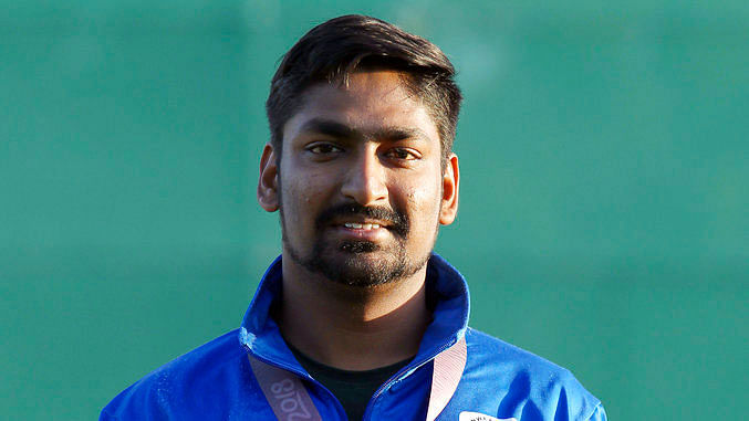 Ankur Mittal stands on the podium at the 21st Commonwealth Games.