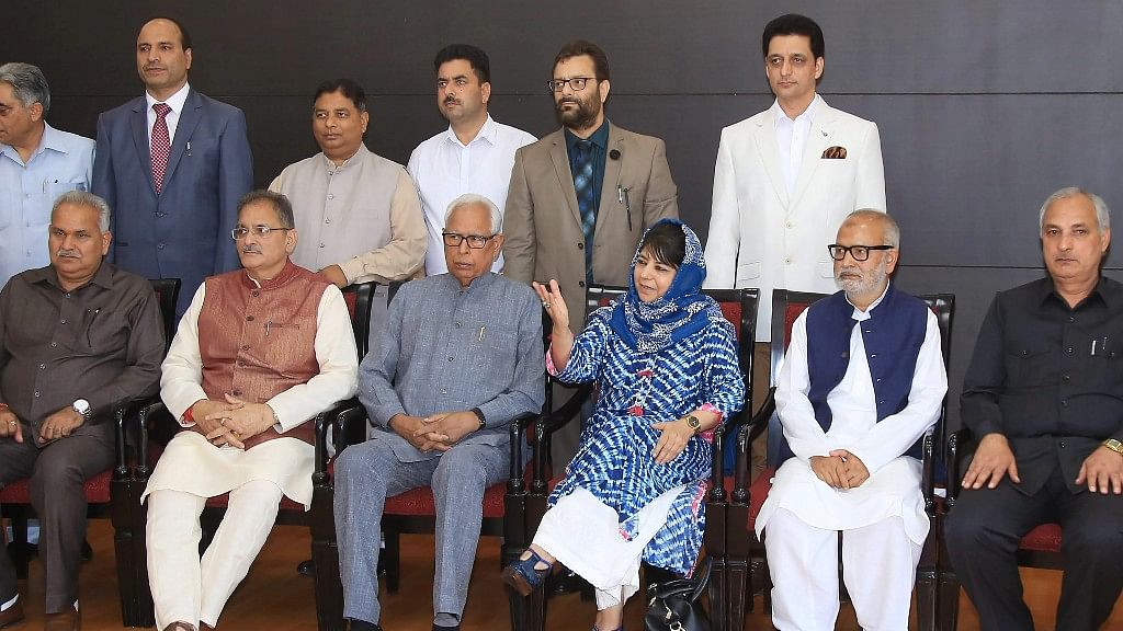 Jammu &amp; Kashmir Governor NN Vohra and Chief Minister Mehbooba Mufti with Deputy Chief Minister Kavinder Gupta pose for a group photograph with the newly appointed minister after a reshuffle in Jammu on Monday.
