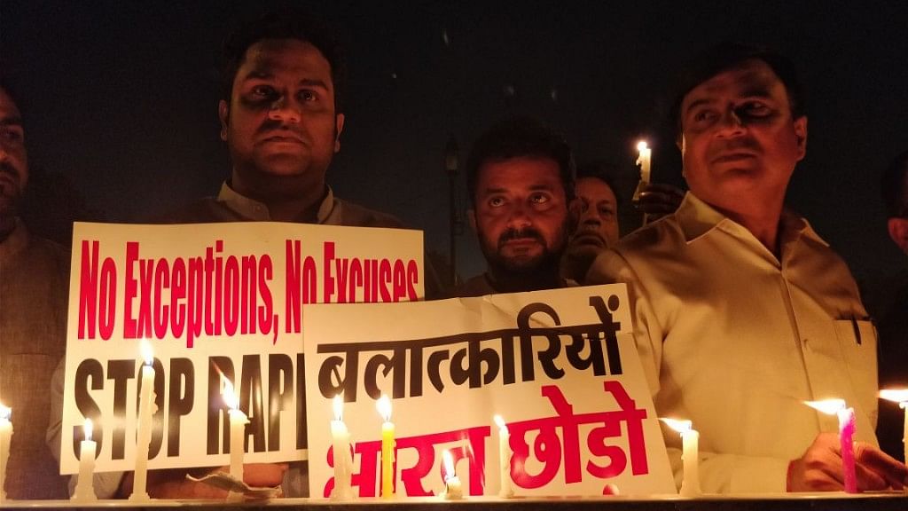 Hundreds gathered on 12 April midnight in New Delhi to protest against the Kathua and Unnao rape cases.