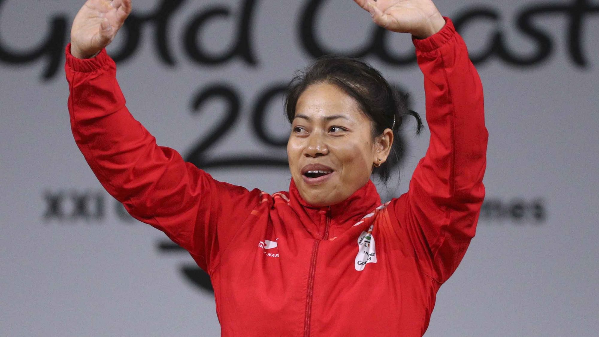 India’s women’s 53 kg weightlifting gold medalist Sanjita Chanu waves during the medal ceremony.