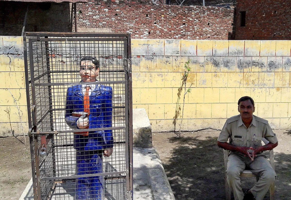 A statue of Dr Bhimrao Ambedkar locked in an iron cage, in Badaun on Thursday. A statue of the leader recently raised controversy after it was painted in saffron.
