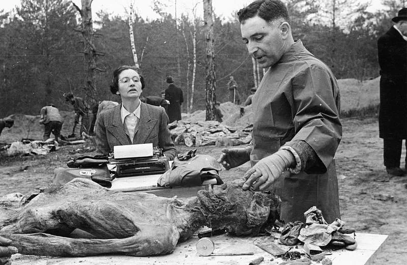 Member of the International Medical Commission, Dr Vincenzo Palmieri, Professor of Forensic Medicine and Criminology at the University of Naples, dictating results of the body examination to his personal assistant. <i>Date: 30 April 1943 (World War II)</i>