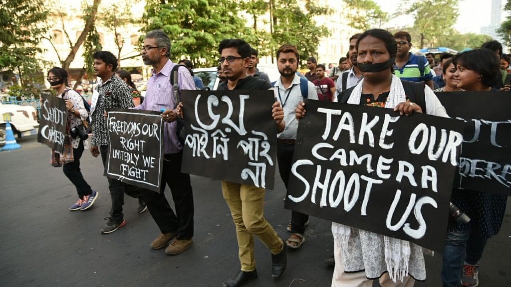 Journalists take out a protest march after a photojournalist was stripped and beaten in Kolkata.