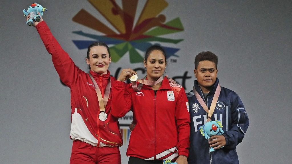 Indian women’s 69-kg weightlifting gold medallist Punam Yadav, centre, stands with England’s silver medalist Sarah Davies, left, and Fiji Bronze medalist Apolonia Vaivai during the medal ceremony at the Commonwealth Games in Gold Coast, Australia, on Sunday.