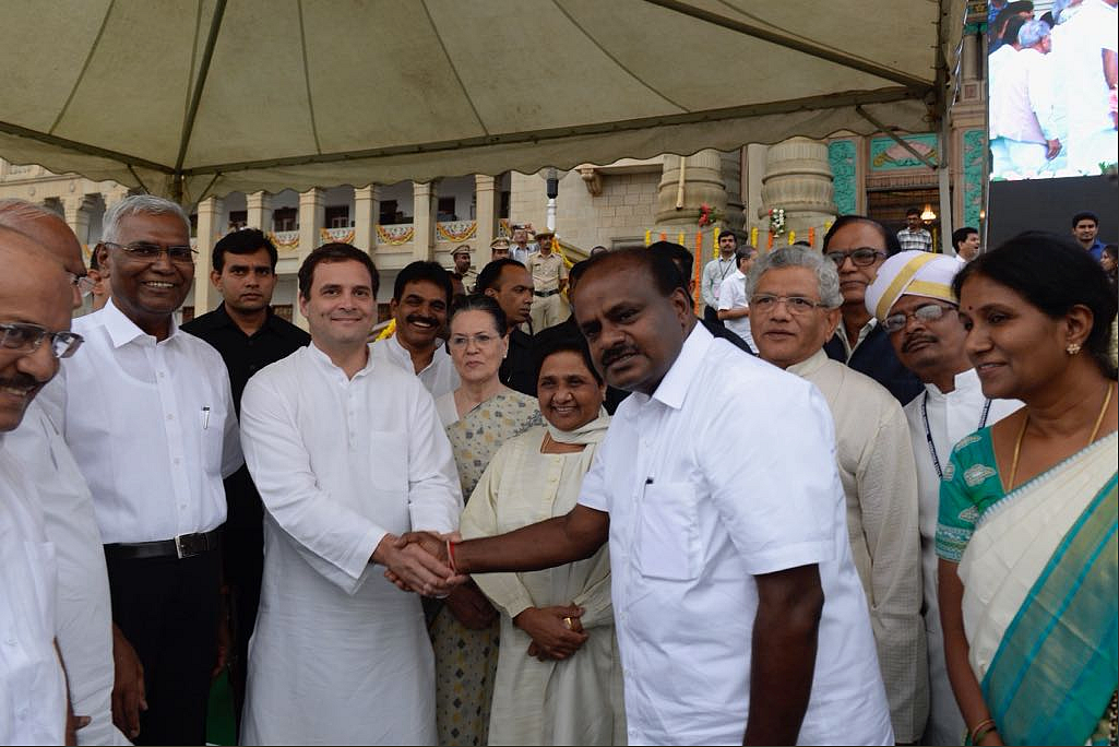 Rahul Gandhi clasps hands with new Karnataka Chief Minister HD Kumaraswamy.