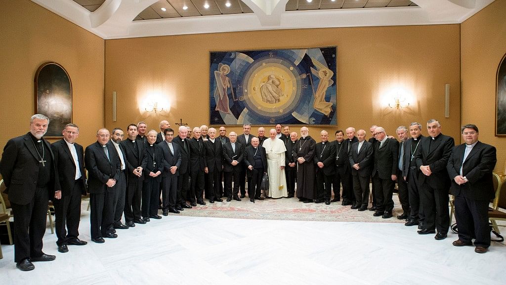 Pope Francis poses with Chilean bishops after a meeting at the Vatican