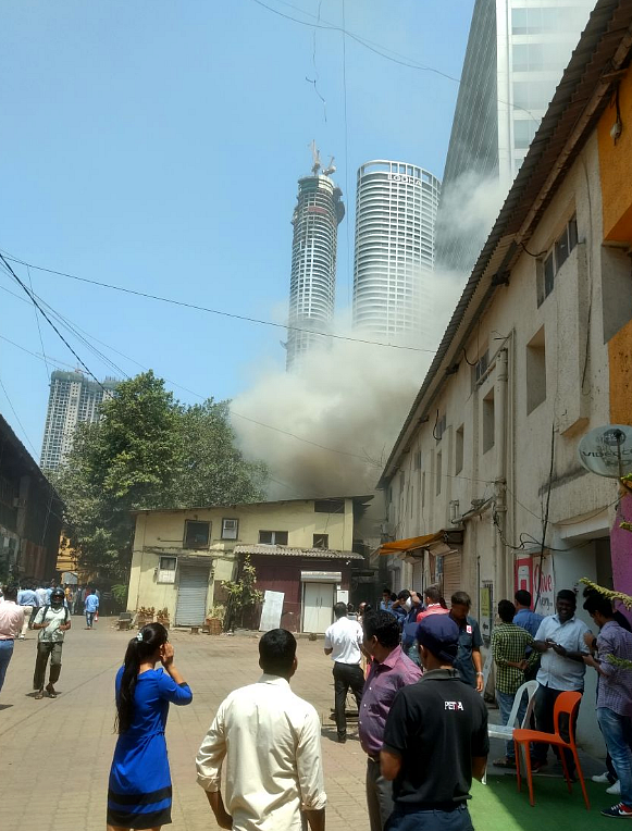 Smoke comes out of a building in the Todi Mills compound.