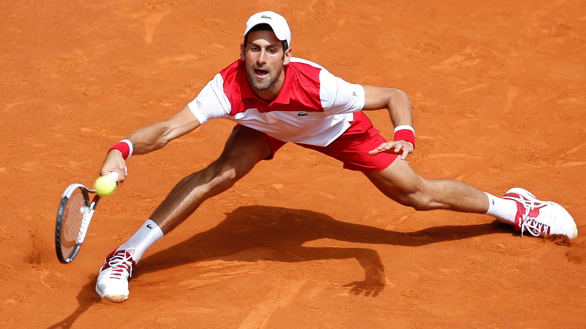 Novak Djokovic of Serbia returns the ball to Kyle Edmund of Britain during the Madrid Open.