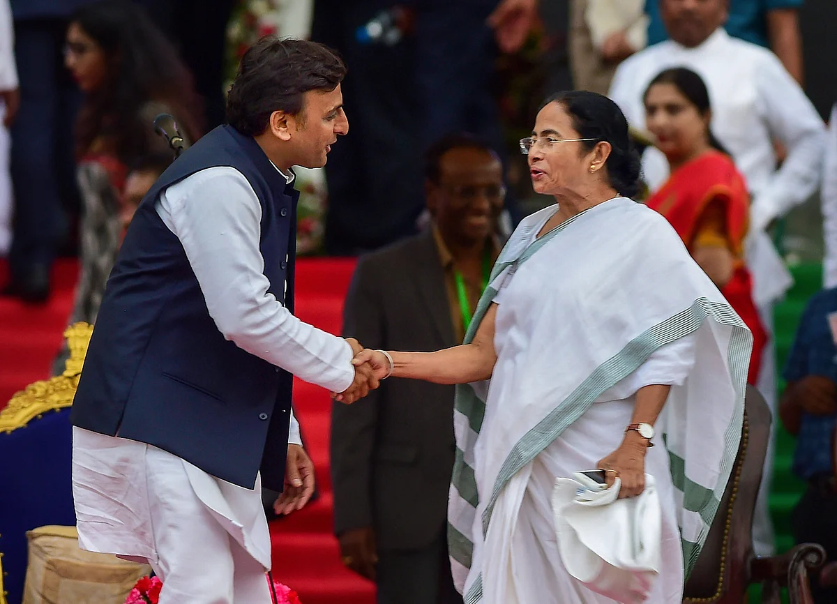 Akhilesh and Mamata share a handshake.